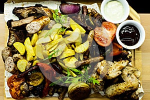 Dish for the company grilled meat. Steak, vegetables and sausages