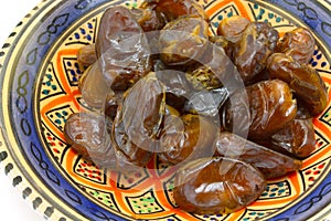 Dish of dates on a white background