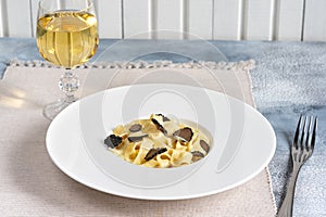 Dish of delicious italian pasta tagliatelle with truffle mushroom chips