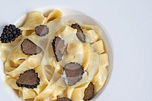 Dish of delicious italian pasta tagliatelle with truffle mushroom chips