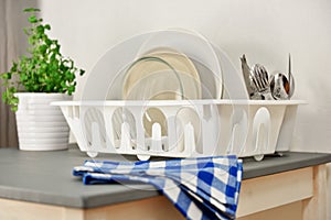 Dish drainer with plates and silverware photo