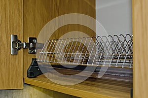 Dish dryer in a kitchen cabinet, close-up