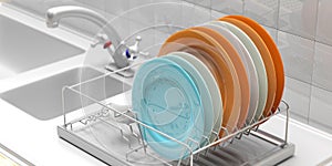 Dish drying rack with colorful plates on a white kitchen counter. 3d illustration