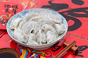 A dish of dumplings under the background of red couplets during the Spring Festival