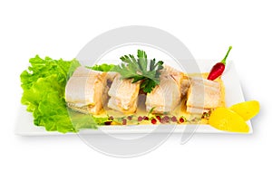 Dish of fish with greens and lemon isolated