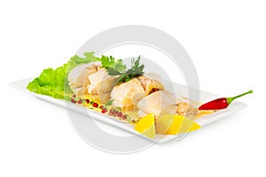 Dish of fish with greens and lemon isolated