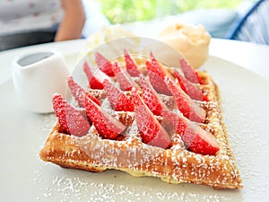 Dish of fresh strawberry waffle.