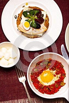 A dish of the fried egg with the stewed peppers. Top view.