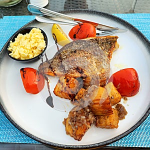 Dish with fried fish and potatoes