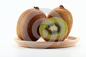A Dish of Full And Cleaved Kiwi Fruits
