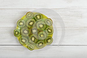 Dish full of kiwi slices in the image center