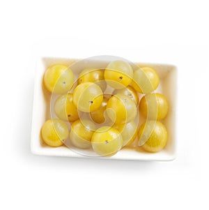 Dish full of ripe fresh yellow cherry tomatoes