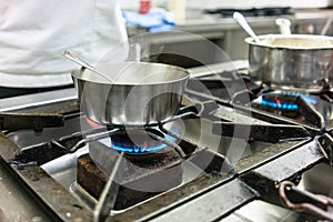 Dish on gas stove in restaurant or hotel kitchen