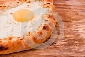 Dish of Georgian cuisine - Khachapuri on a wooden background