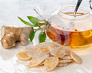 Dish of green tea, ginger root and slices of candied ginger
