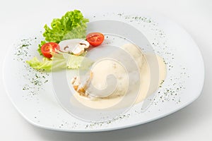 The dish of grilled chicken with cream souse and garnished