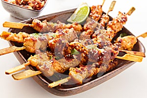 Dish of Grilled Meat on Wooden Skewers with Lime