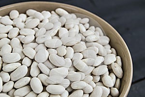 Dish of haricot bean, haricot bean with grains to make meal fresh and natural dried bean sprouts, in a plate on a wooden floor.
