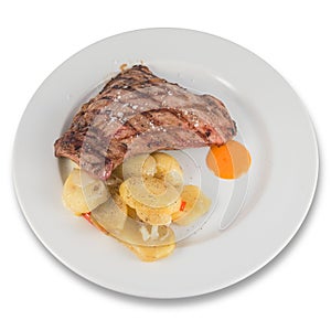 Dish of Iberian pork presa with baked potato slices.