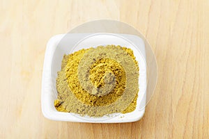 Dish with khmeli suneli spice mixture on wood