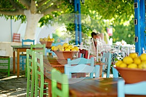 A dish of lemons in typical greek outdoor cafe