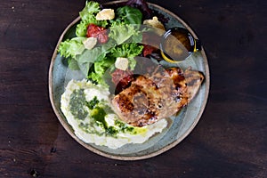 dish with mashed potato fish fillet and fried tilapia salad