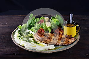 dish with mashed potato fish fillet and fried tilapia salad