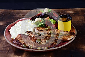 dish with mashed potato fish fillet and fried tilapia salad