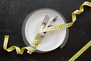 Dish and measuring tape concept diet