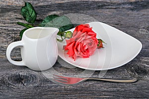 Dish, milk jug and rose