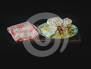 a dish of nasi goreng hijau, a traditional Indonesian green chili fried rice on black background