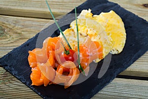 Dish of Norwegian cuisine of cooked omlette fried and served with salmon