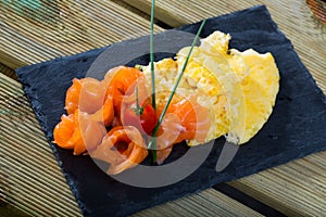 Dish of Norwegian cuisine of cooked omlette fried and served with salmon