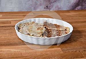 Dish with pancakes on a taule