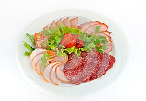 Dish with pastrami and salami slices isolated on white.