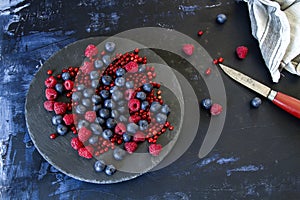 A dish with redcurrants, raspberries and blueberries