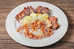 Dish with rice and beans arroz com feijao seasoned with sausag photo