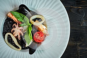 Dish of risotto with squid ink on grey plate jpg