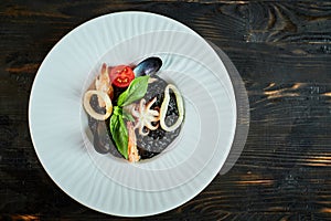 Dish of risotto with squid ink on grey plate jpg