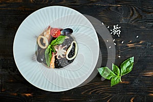 Dish of risotto with squid ink on grey plate jpg