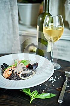 Dish of risotto with squid ink on grey plate jpg