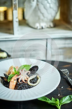 Dish of risotto with squid ink on grey plate jpg