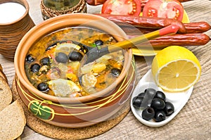 Dish of russian hodgepodge soup and other food. photo