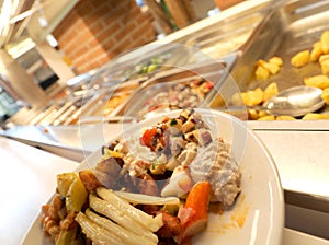 dish at self service restaurant with many raw and cooked foods photo