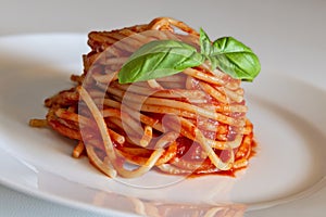 Dish with spaghetti tomato and basil