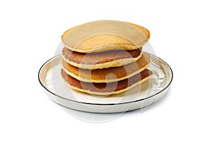 Dish with stacked pancakes on white