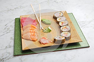 Dish with sushi roles on marble table