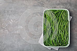 Dish with tasty green beans on table