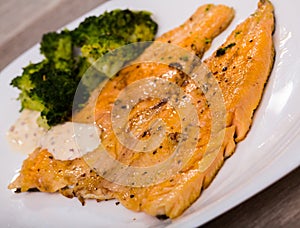 Dish of tasty steak of fried rainbow trout fillet with broccoli