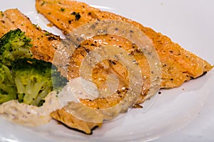 Dish of tasty steak of fried rainbow trout fillet with broccoli